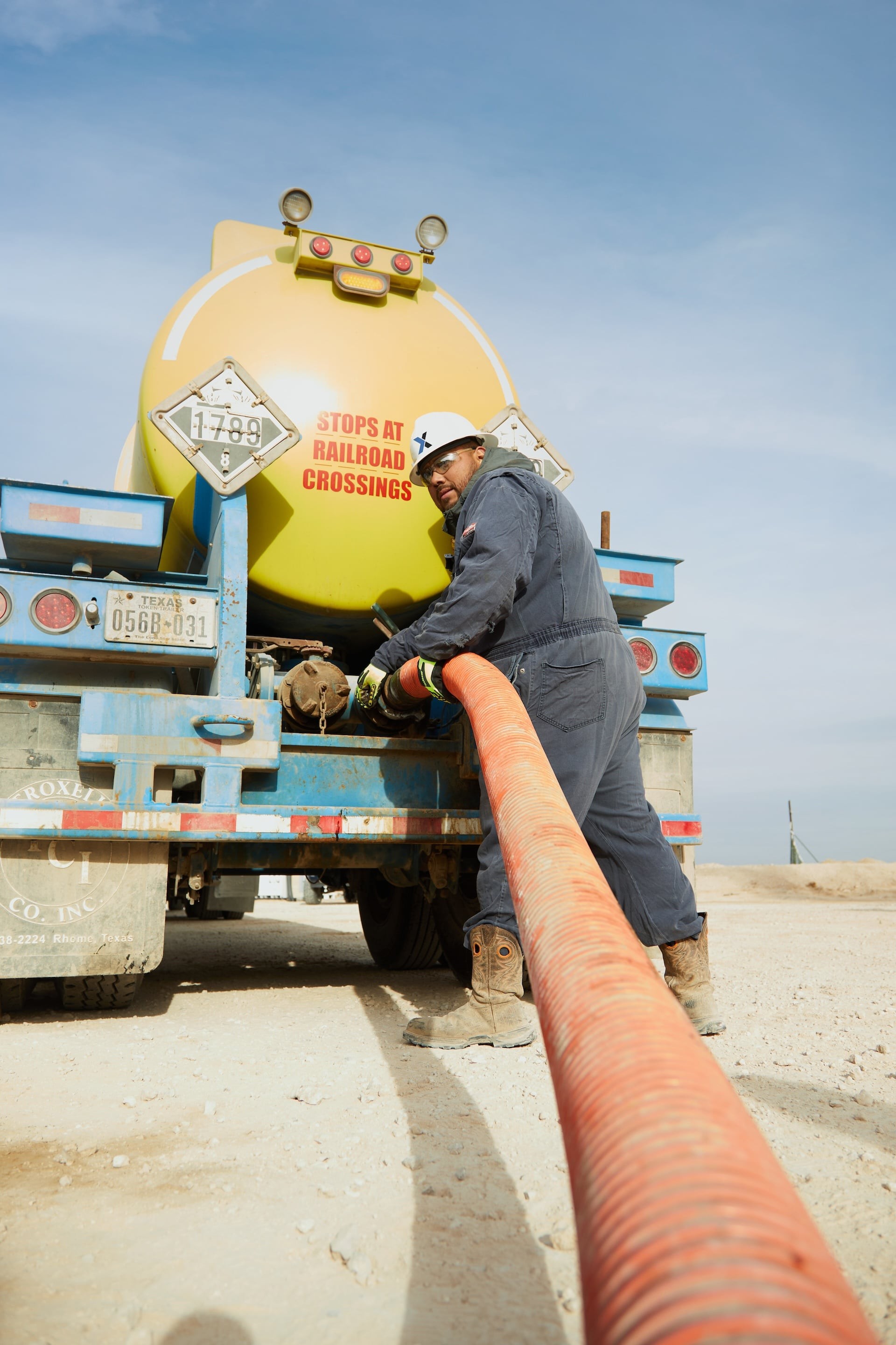 Petroplex worker attaching hose